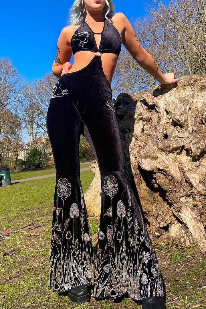 Outdoor shot of model in The Fairy Garden Catsuit, showing velvet texture and botanical sequin design. Ideal for alternative rave and festival fashion.