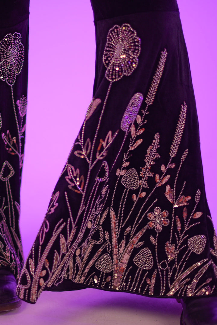Detailed view of The Fairy Garden Catsuit flared legs with intricate silver floral and mushroom embroidery. Perfect for standout festival outfits.