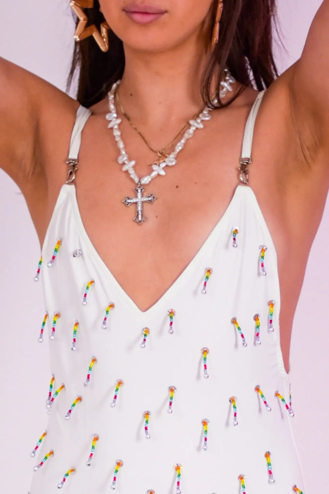 Close-up of White Beaded Swim Bodysuit showing rainbow-colored bead details on soft white fabric, perfect for alternative festival fashion.