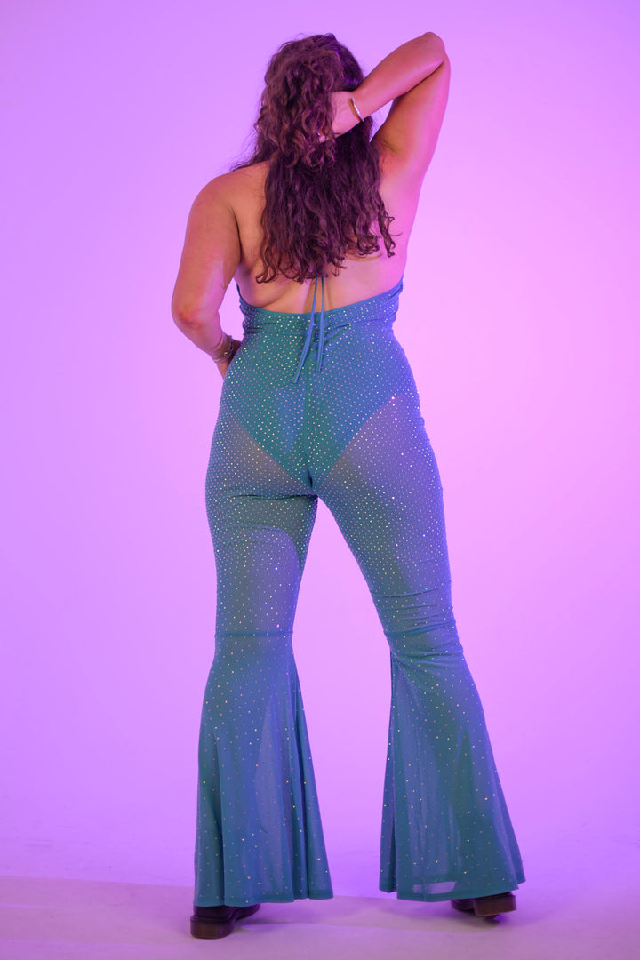 Back view of plus-size model in The Disco Tide Catsuit, featuring open back and rhinestone mesh for rave-ready outfits.