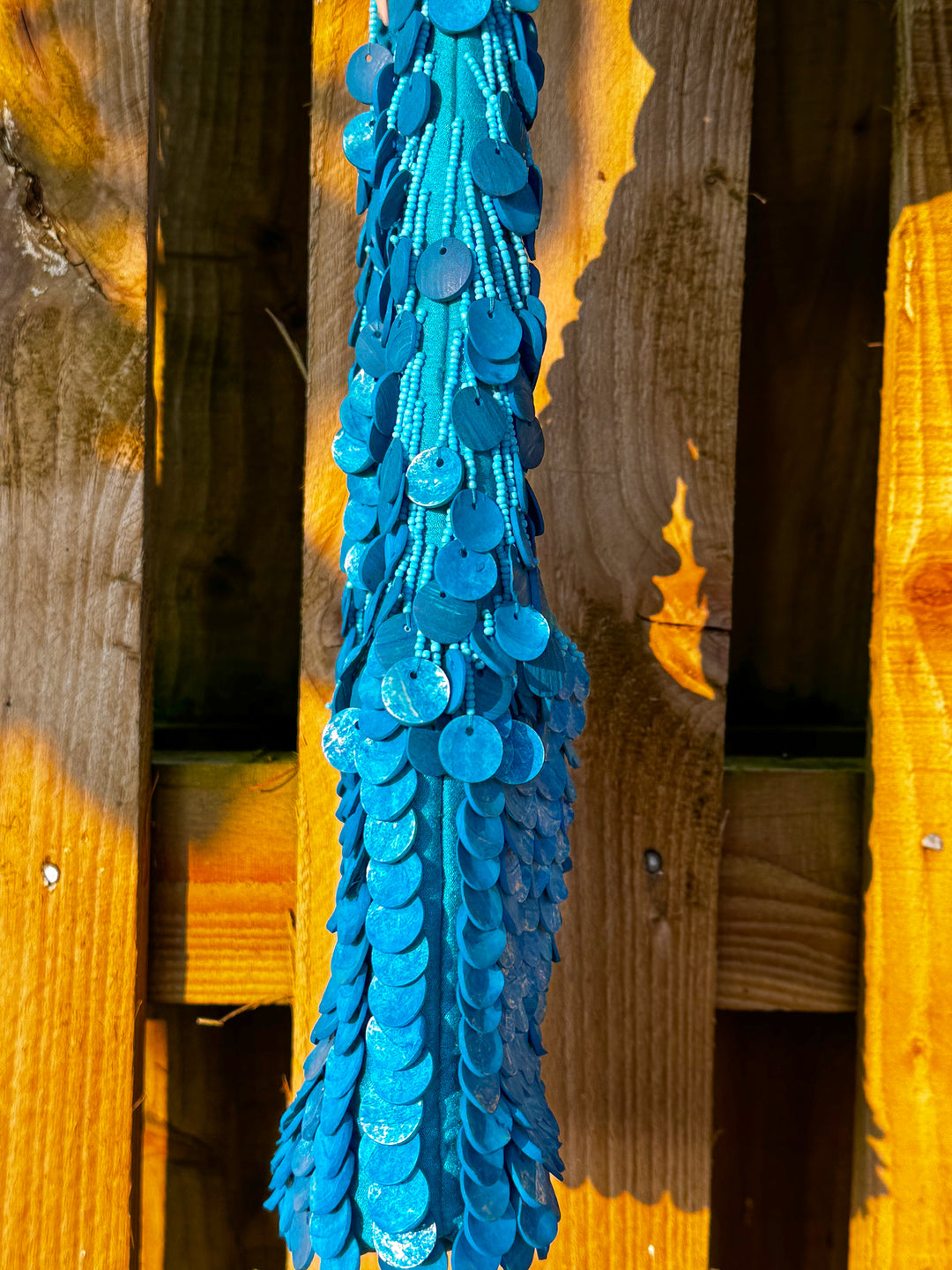 Side view of Oceana Shell Blue Bag highlighting layered blue shell sequins and beaded texture. A bold accessory for festival wear.