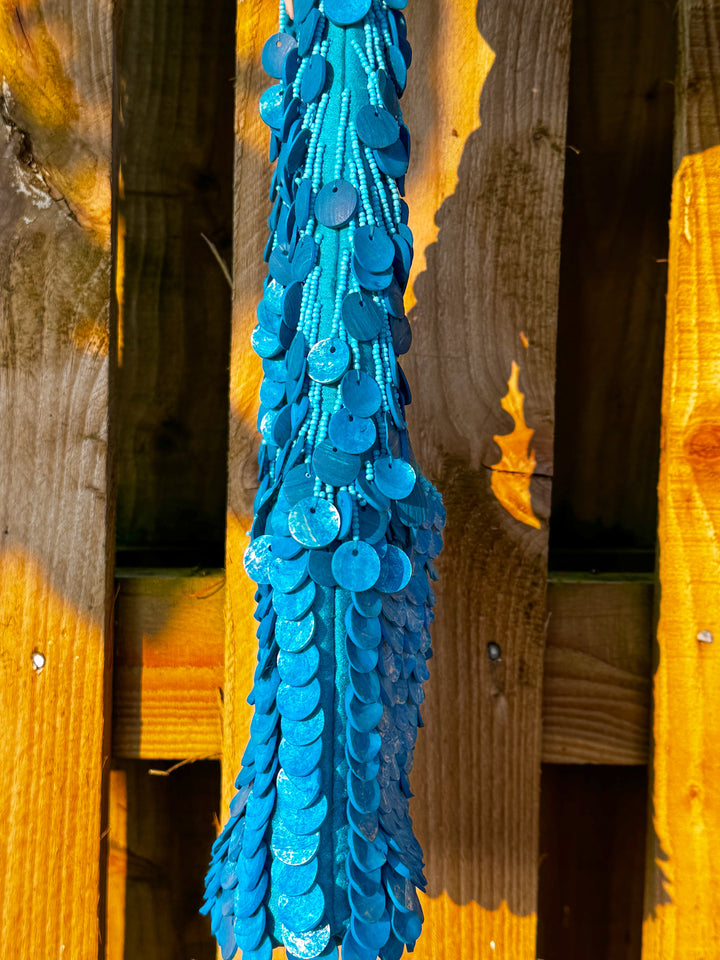 Side view of Oceana Shell Blue Bag highlighting layered blue shell sequins and beaded texture. A bold accessory for festival wear.
