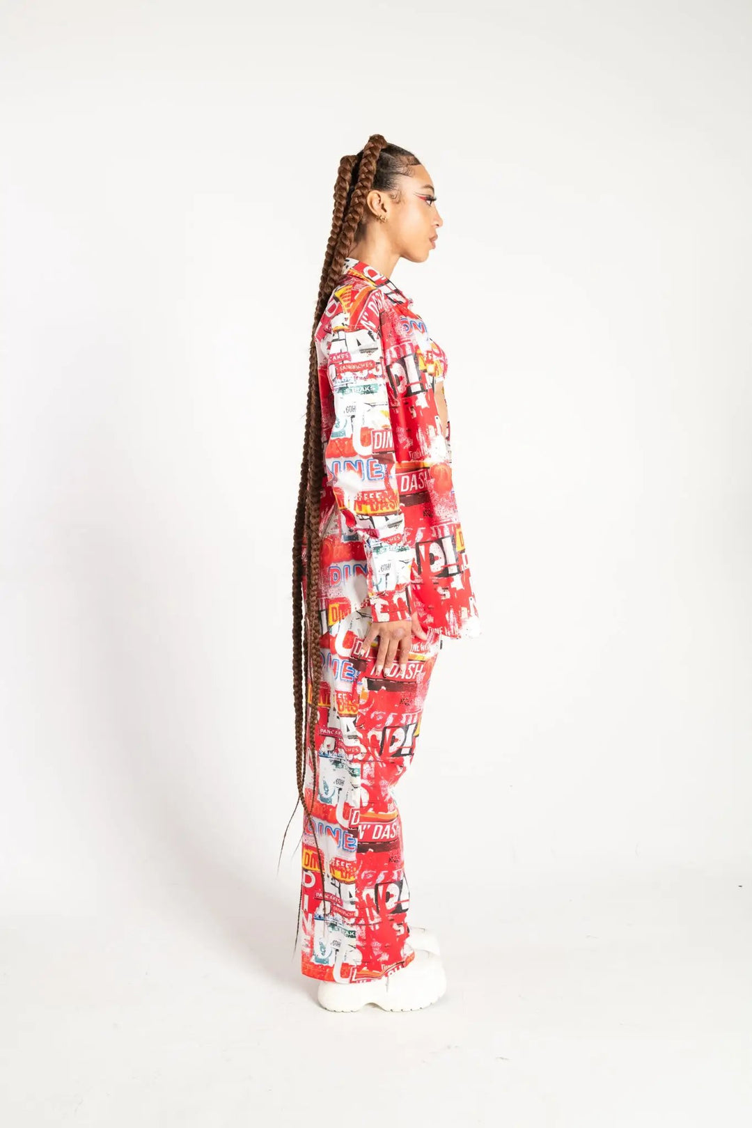 Side view of Dine and Dash Shirt with matching pants, featuring bold text graphics for standout rave and festival wear.