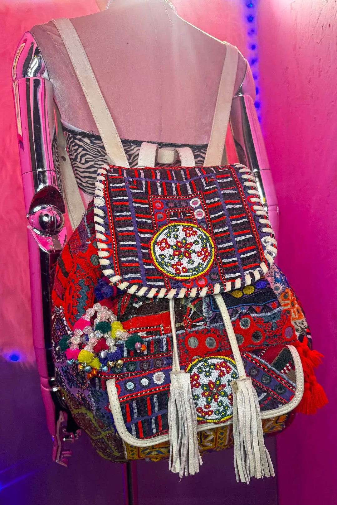 Handcrafted Wren Backpack with multicolor beadwork, patchwork fabric, and boho tassels, designed for rave and festival style lovers.