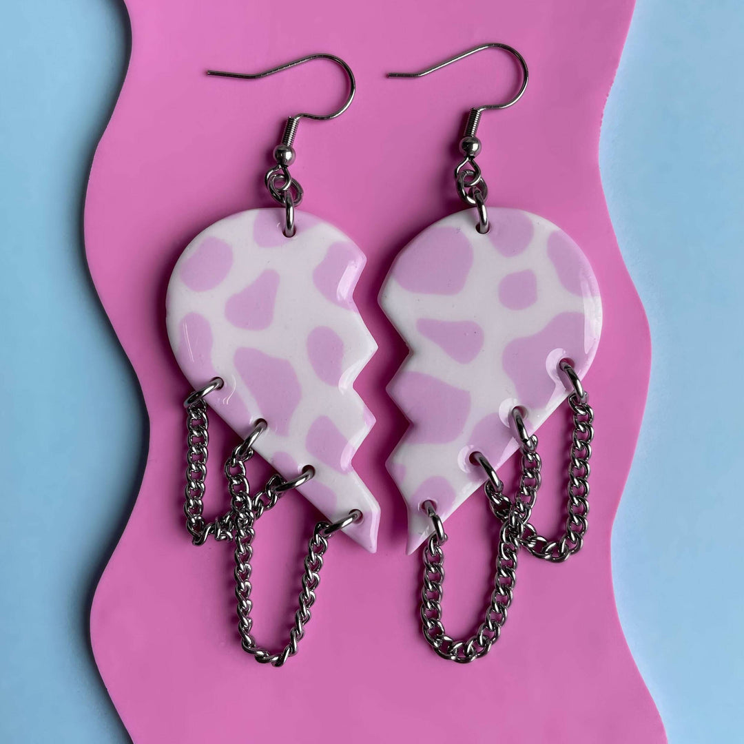 Cow Heartbreakers earrings with pink pattern and chains