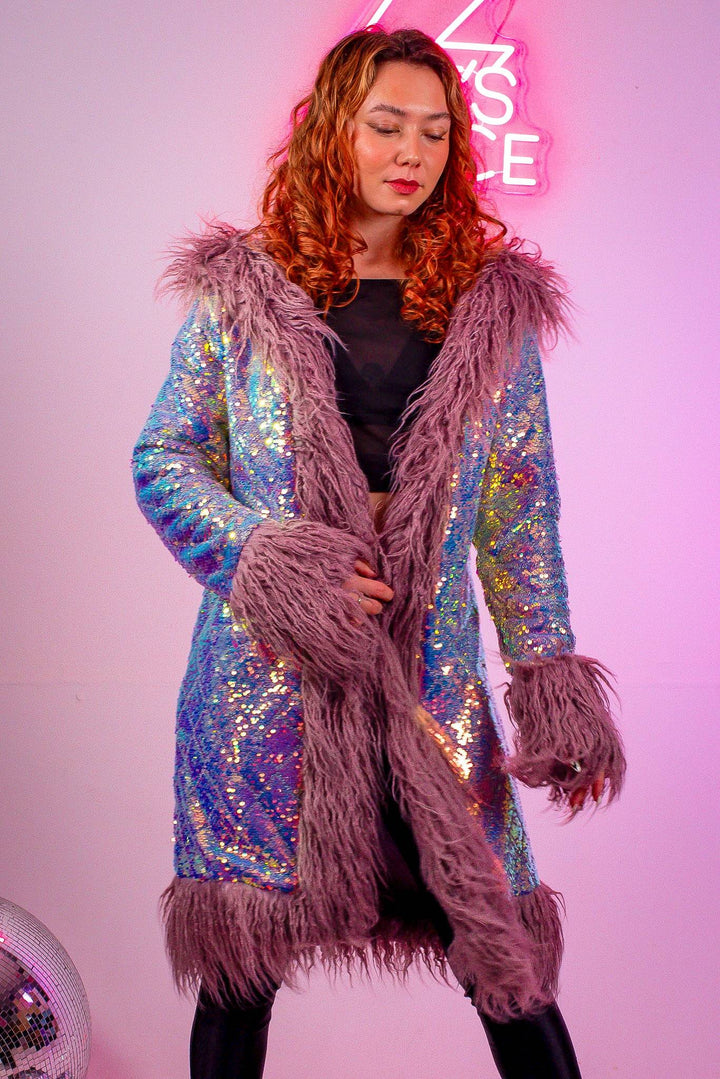 Model in lilac sequin coat with fur trim, front view