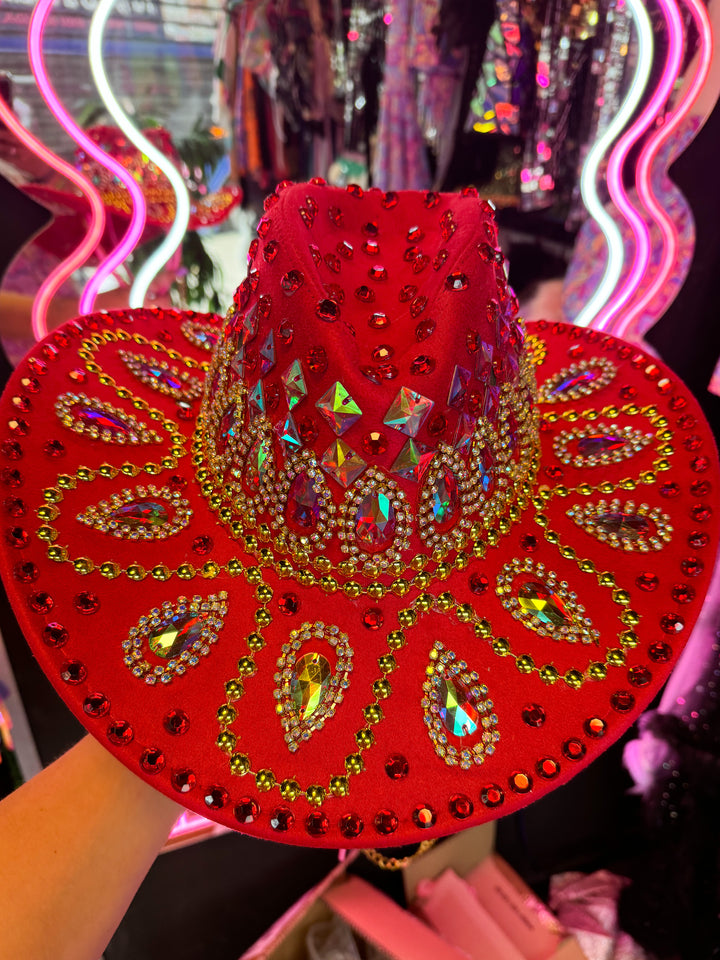 Close-up of red cowboy hat with colorful stones