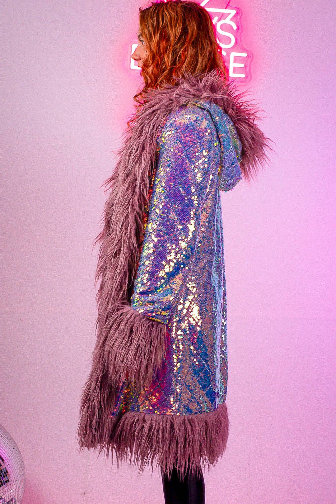 Side profile of lilac hooded sequin coat with fur trim