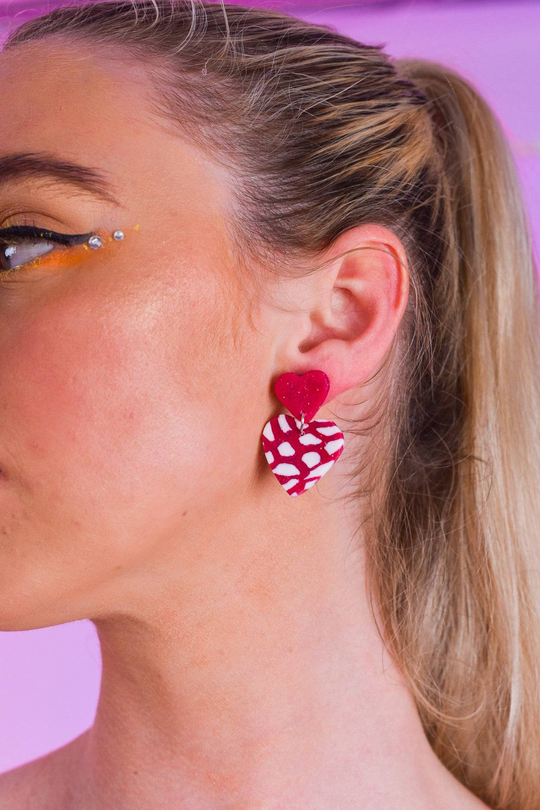 Close-up of double heart earring with sterling silver stud