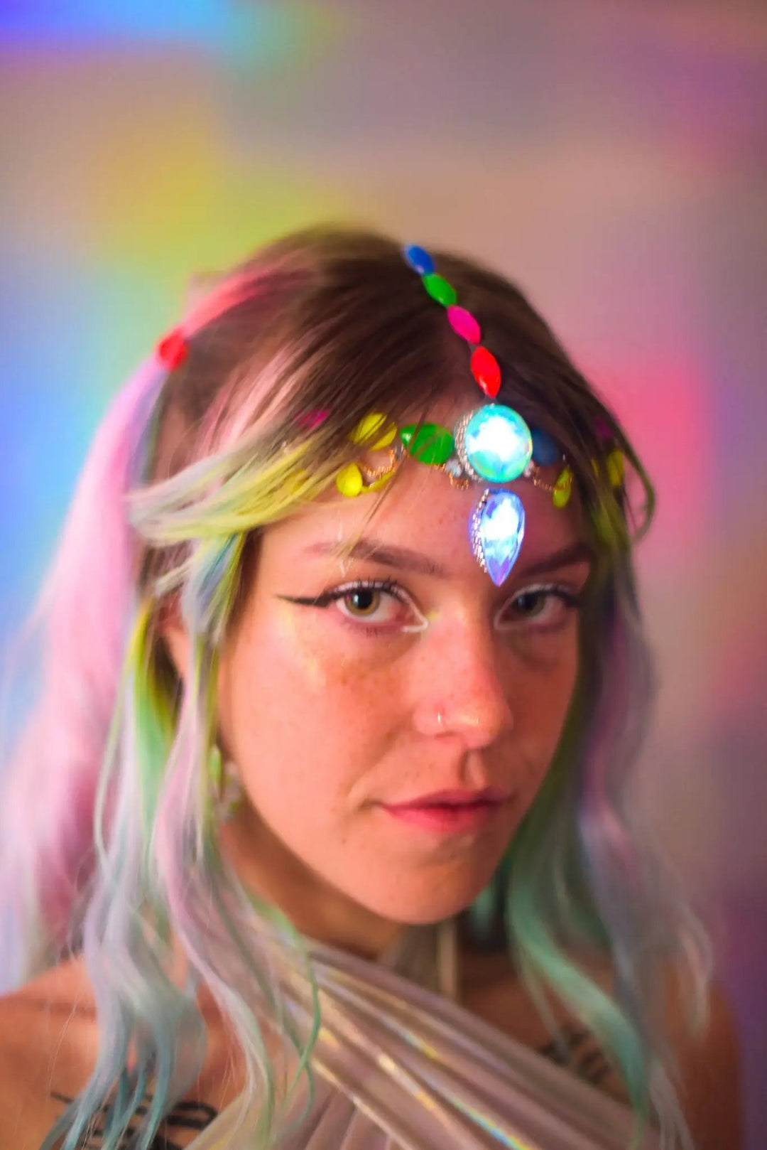 Woman with glowing UV face and hair jewels