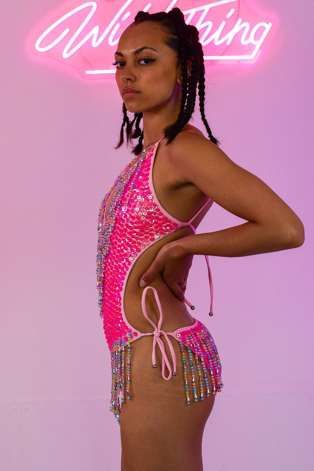 Side profile of pink sequin bodysuit with cut-out design