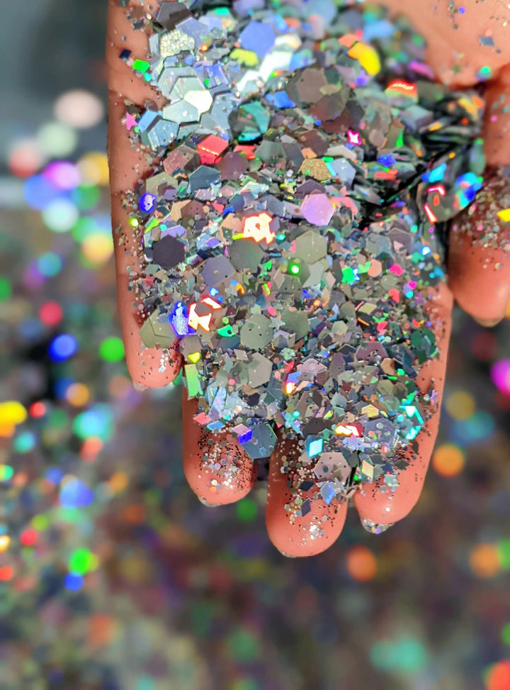 Hand holding vibrant holographic glitter mix