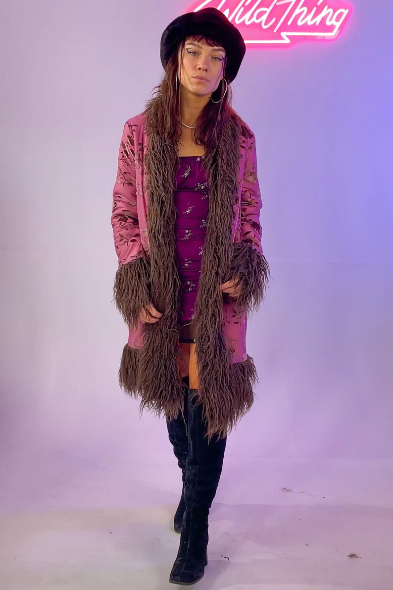 Pink floral coat with brown faux fur trim, studio setting