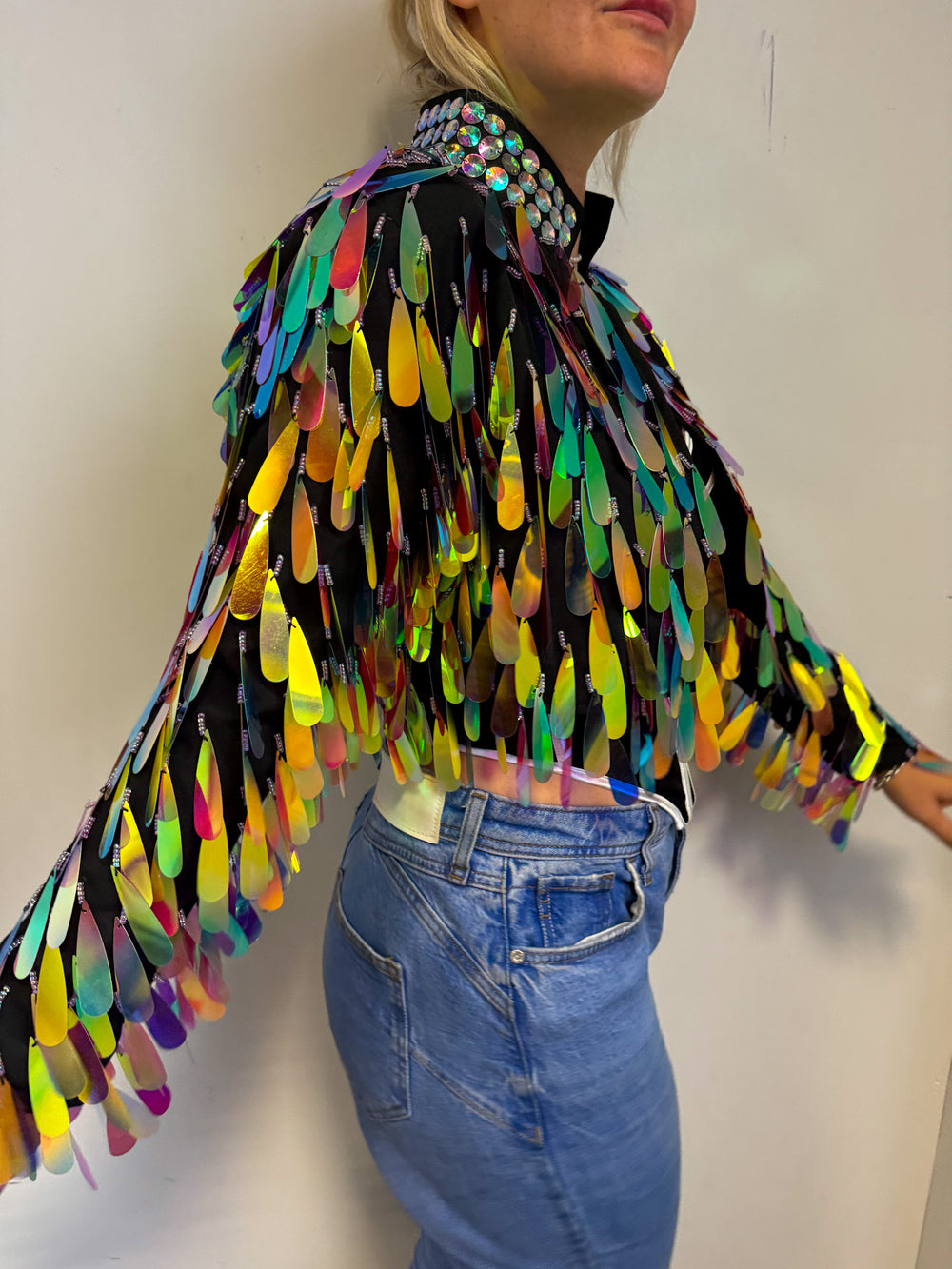 Side view of iridescent sequin jacket with vibrant colors