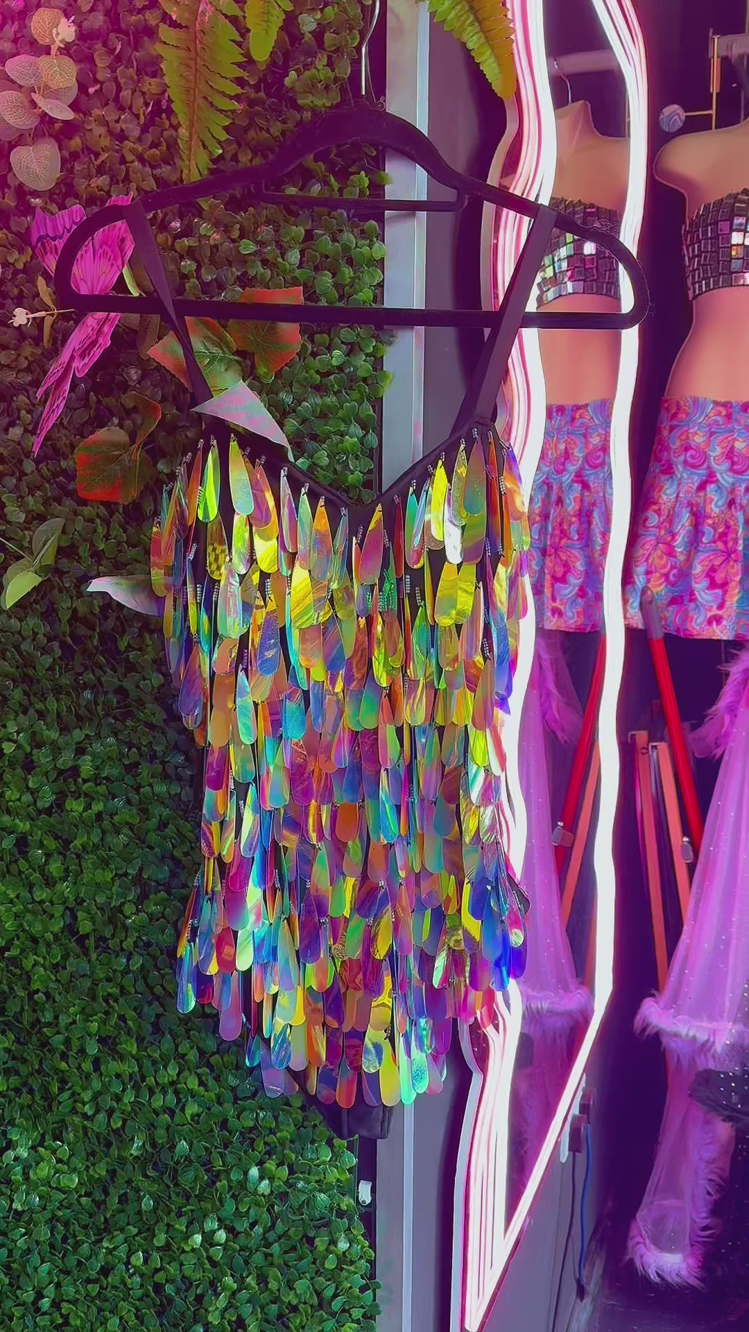 Colorful sequin bodysuit on hanger, vibrant display