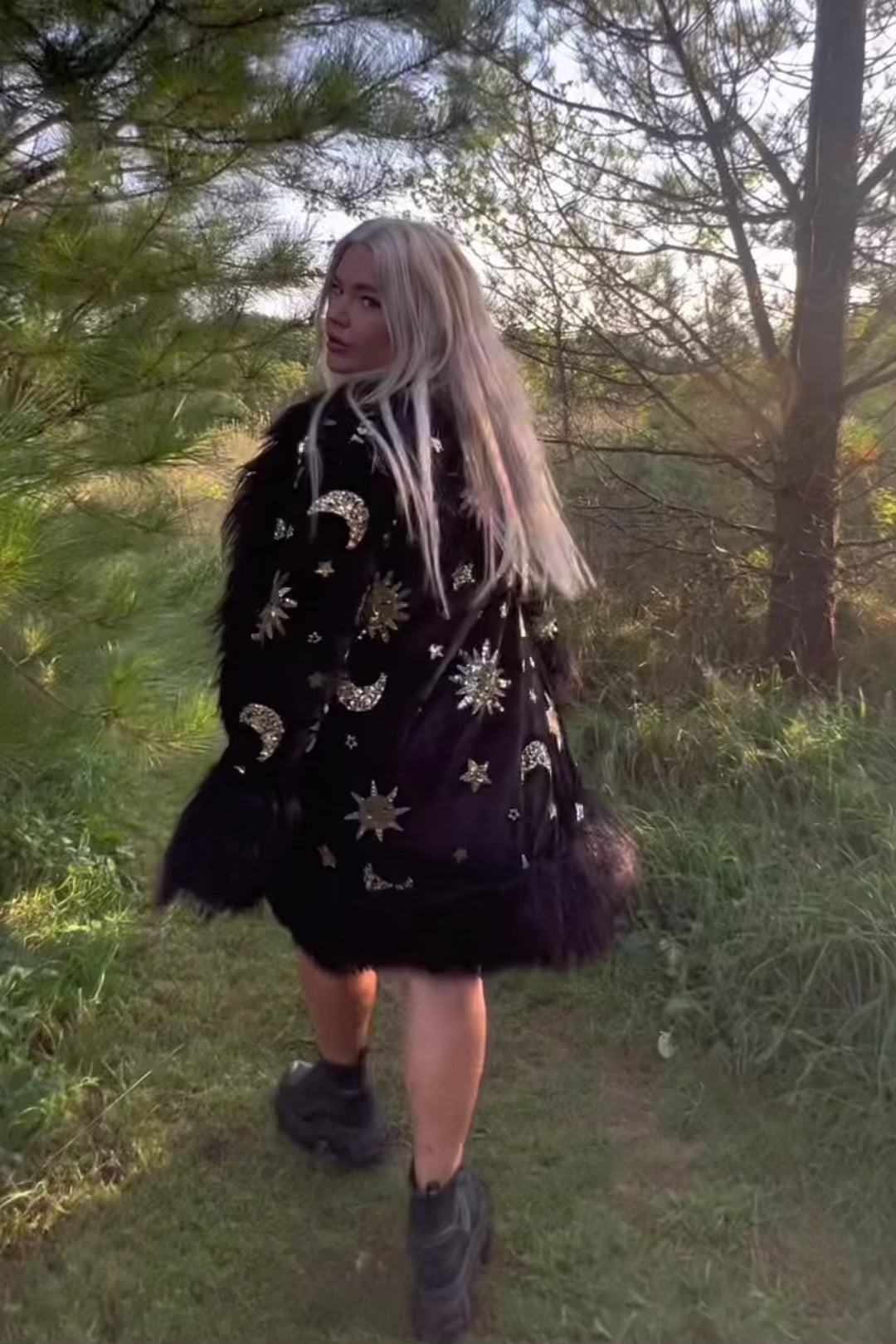 Model in celestial sequin coat walking outdoors