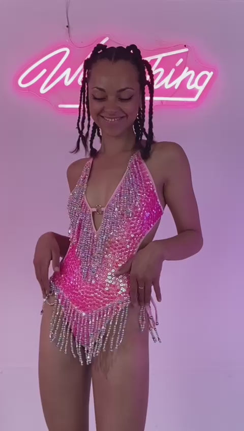 Model smiling in pink sequin bodysuit, front view