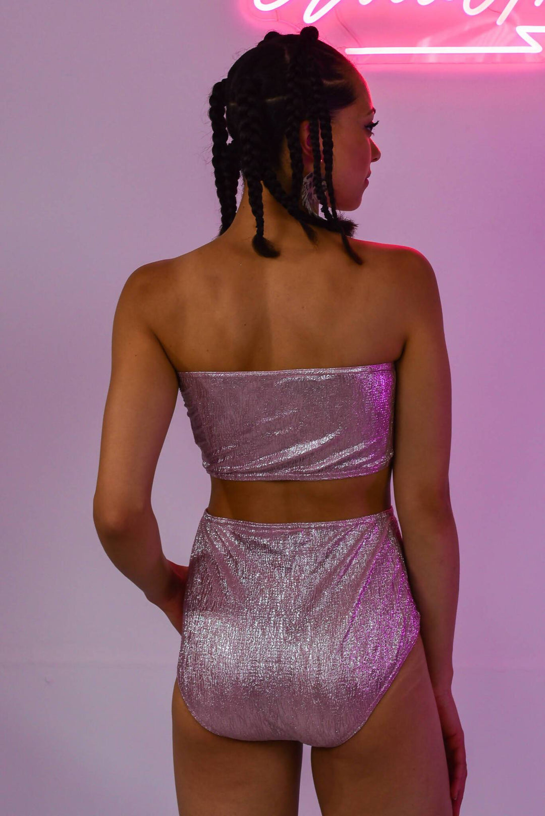 Back view of pink metallic high-waisted shorts and top