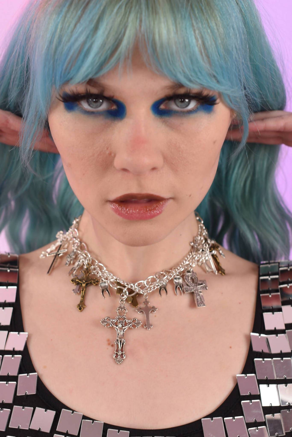 Model wearing Unholy Chains necklace with bold makeup.