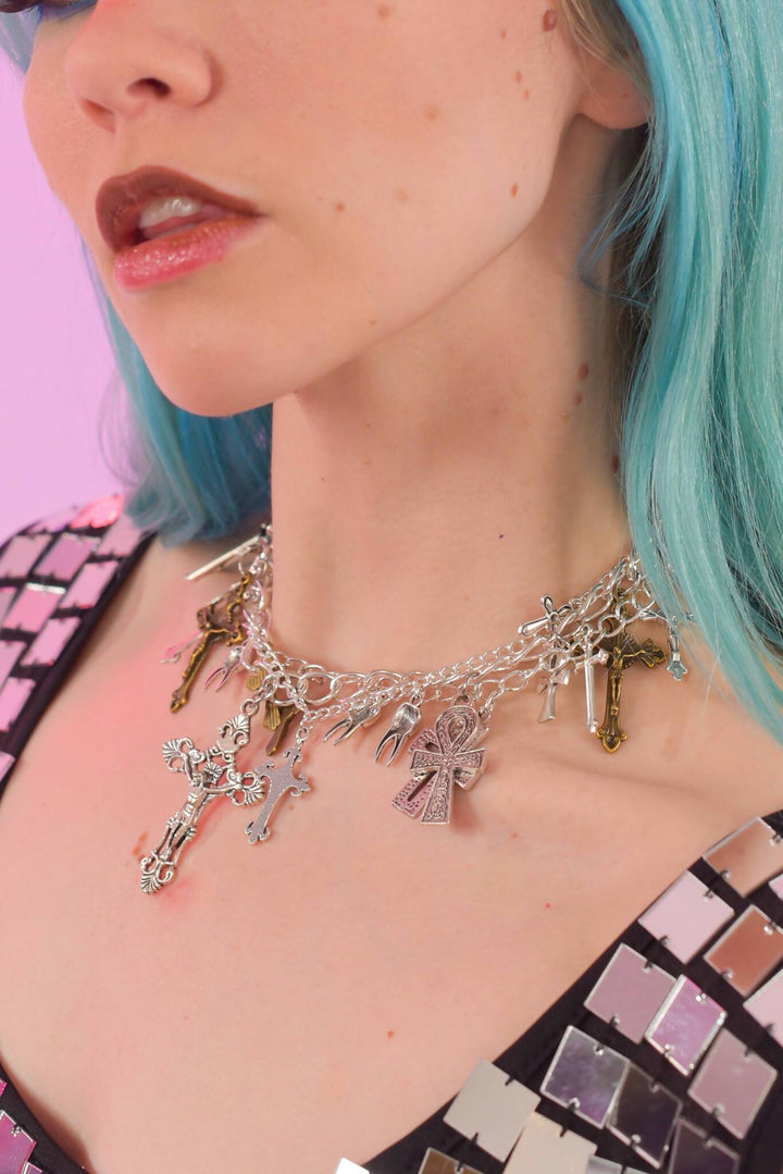 Close-up of Unholy Chains necklace with various charms.