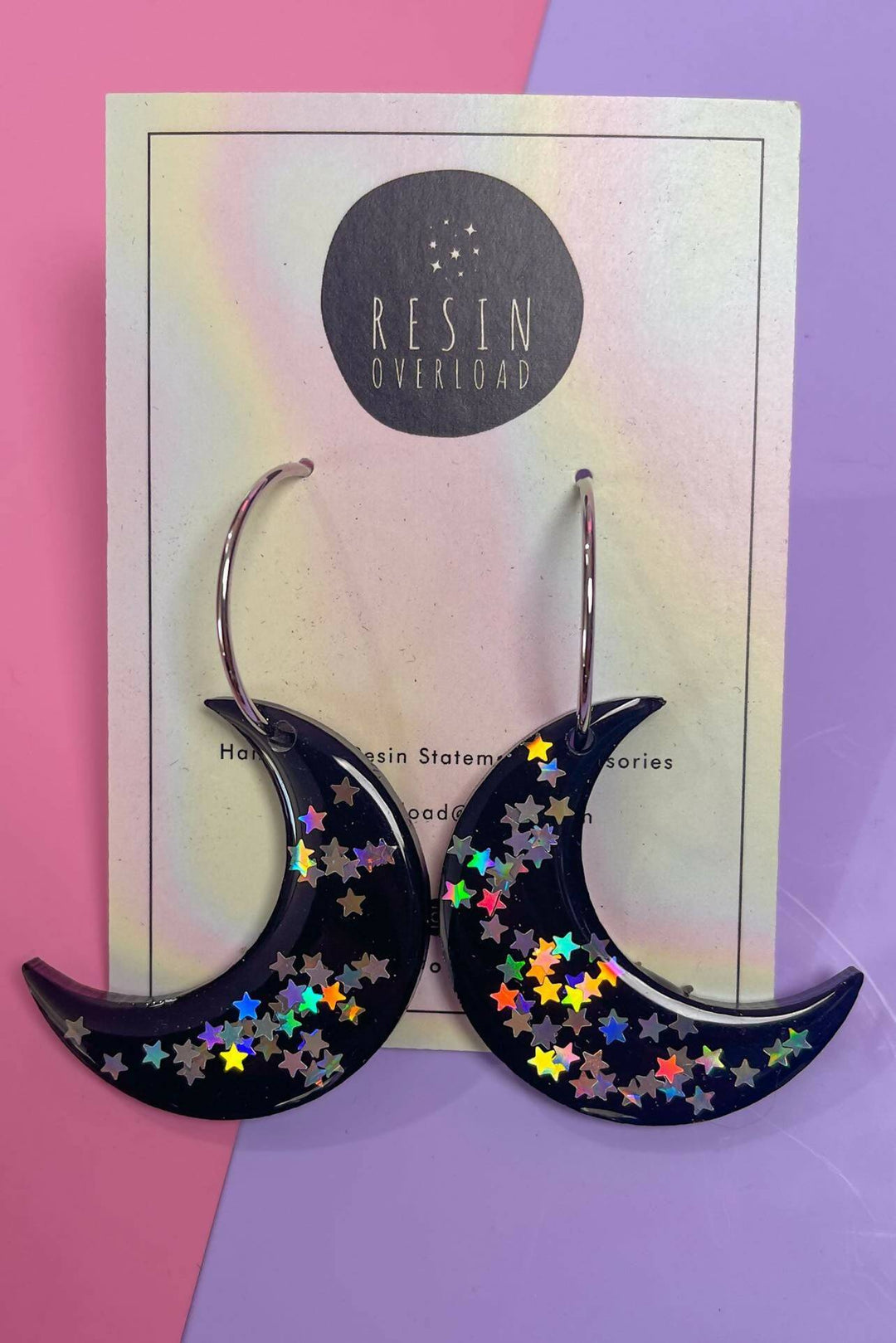 Glittery crescent moon earrings with holographic stars.