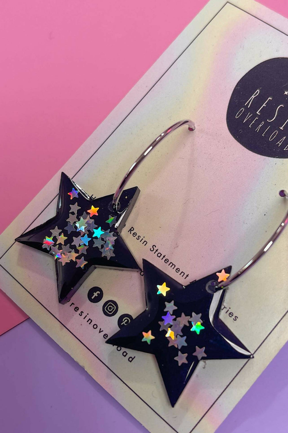 Close-up of star shaped earrings with color shift glitter.