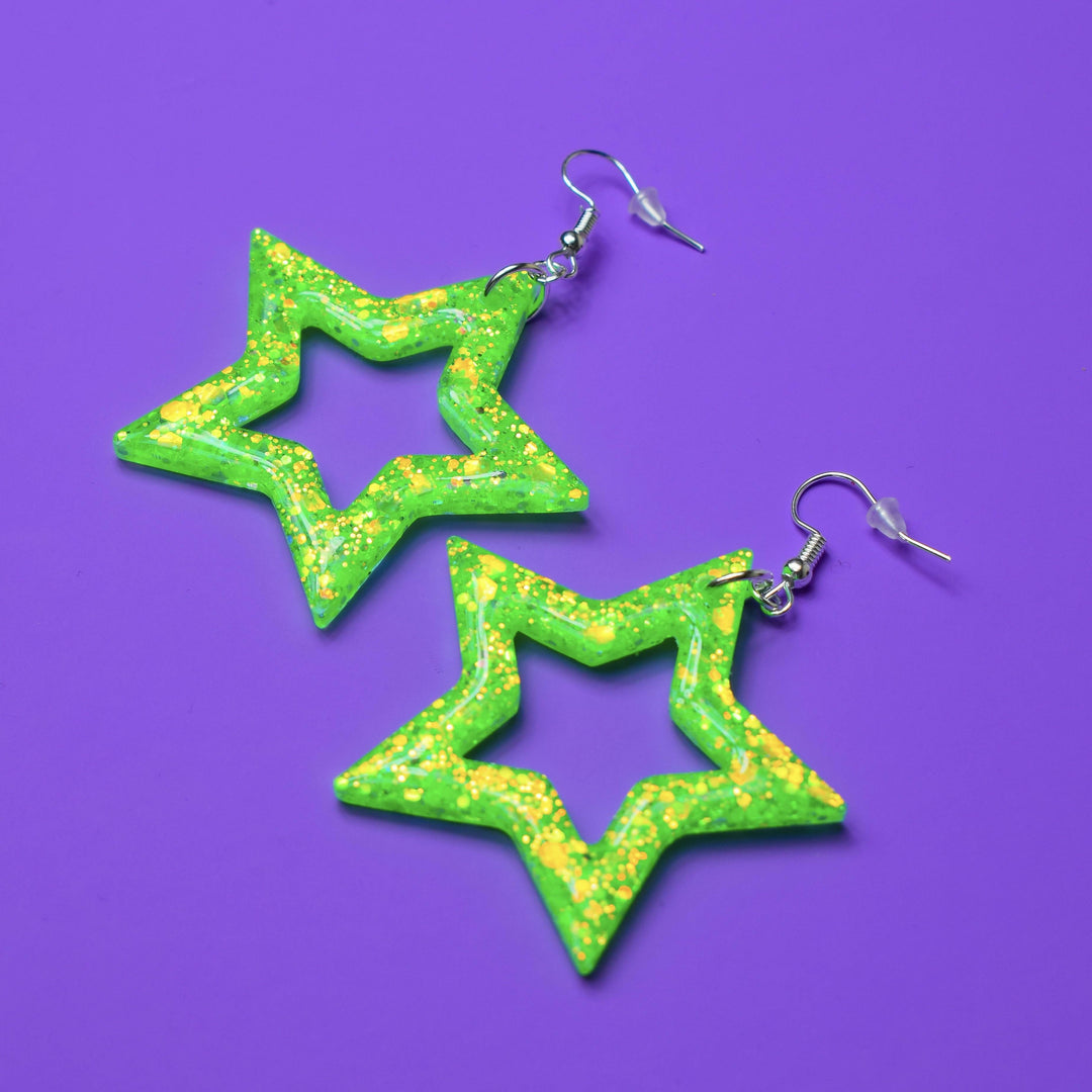 Lime green star-shaped resin earrings with iridescent glitter