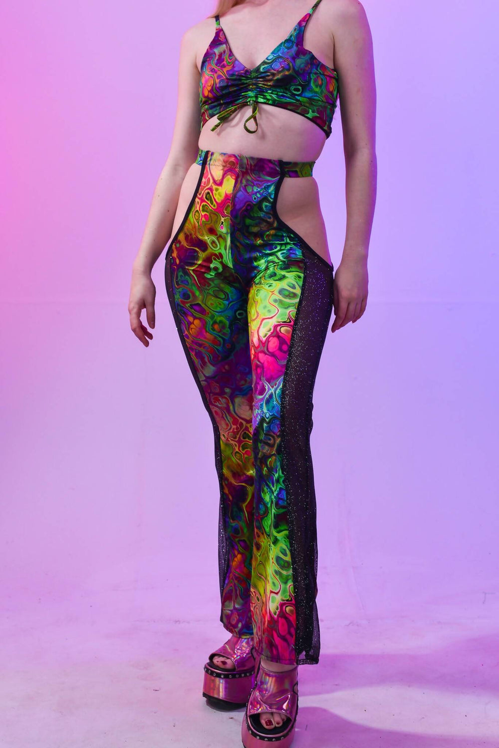 Front view of trippy cut out flares with colorful design