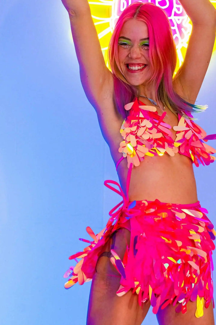 Model smiling in pink sequin bikini top and skirt