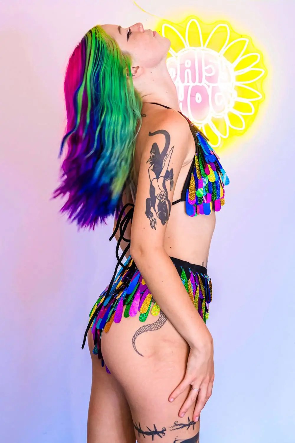 Side profile of model in rainbow sequin bikini