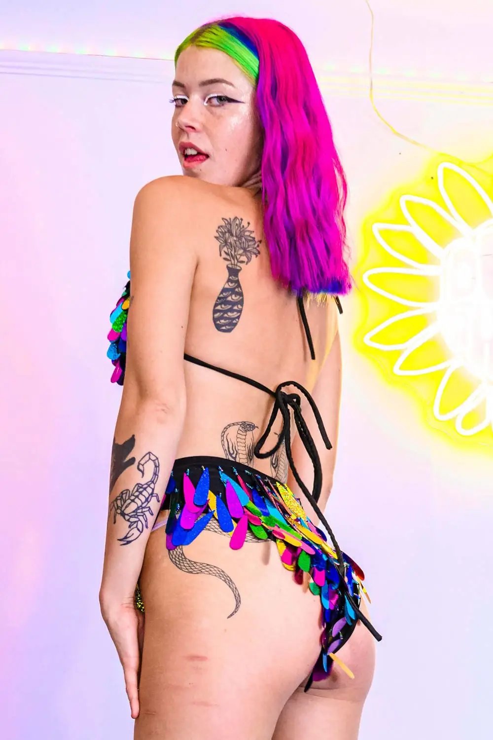 Side view of rainbow sequin bikini with tattoos