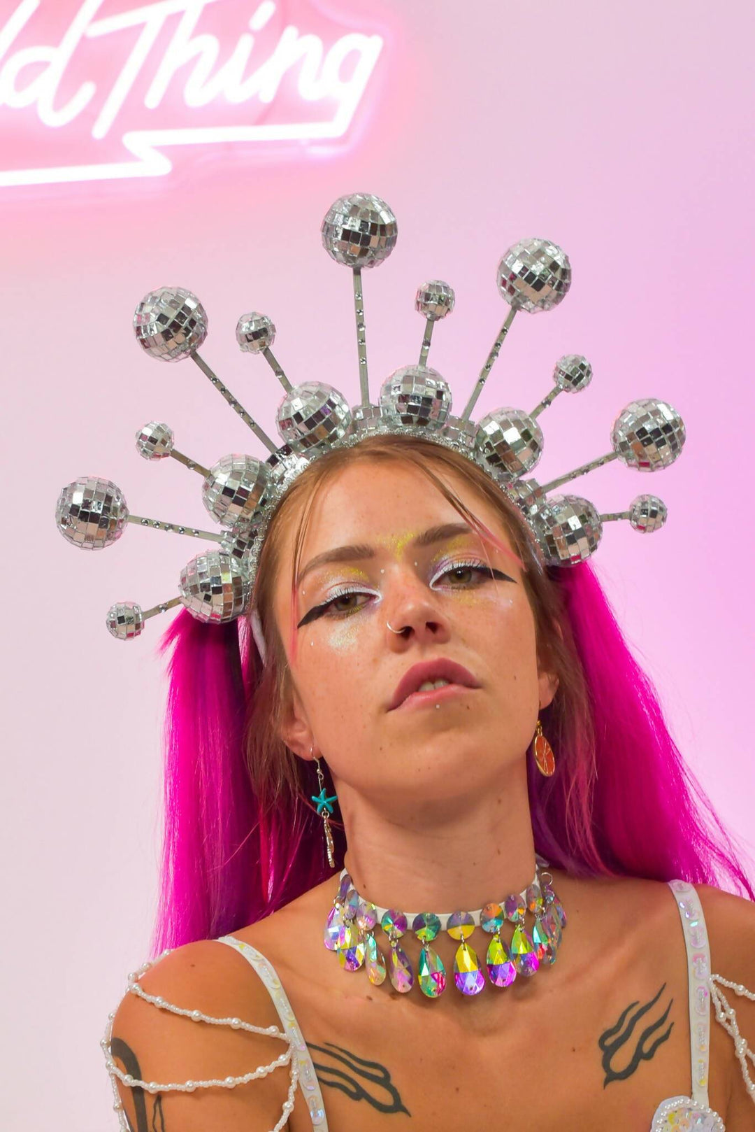 Close-up of disco ball crown headdress and colorful makeup.