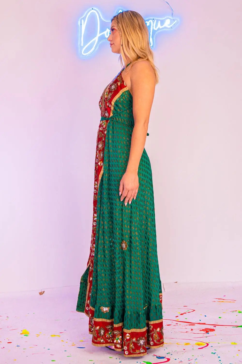 Side view of green maxi dress with red floral details