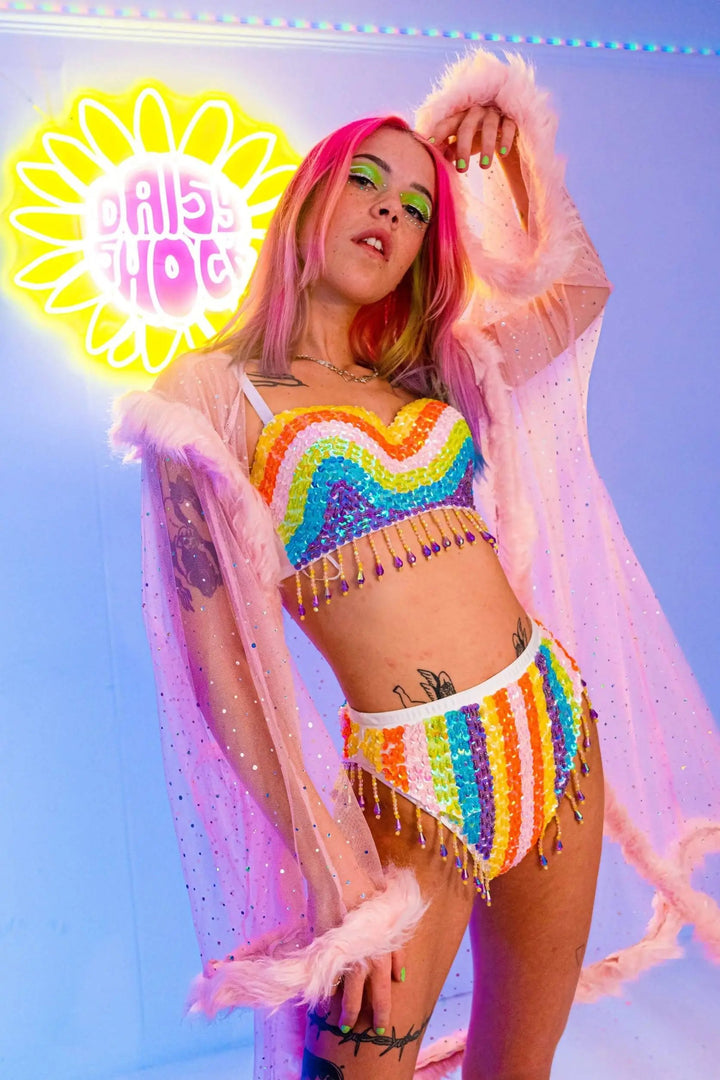 Festival outfit with pink kimono, rainbow top, and neon sign