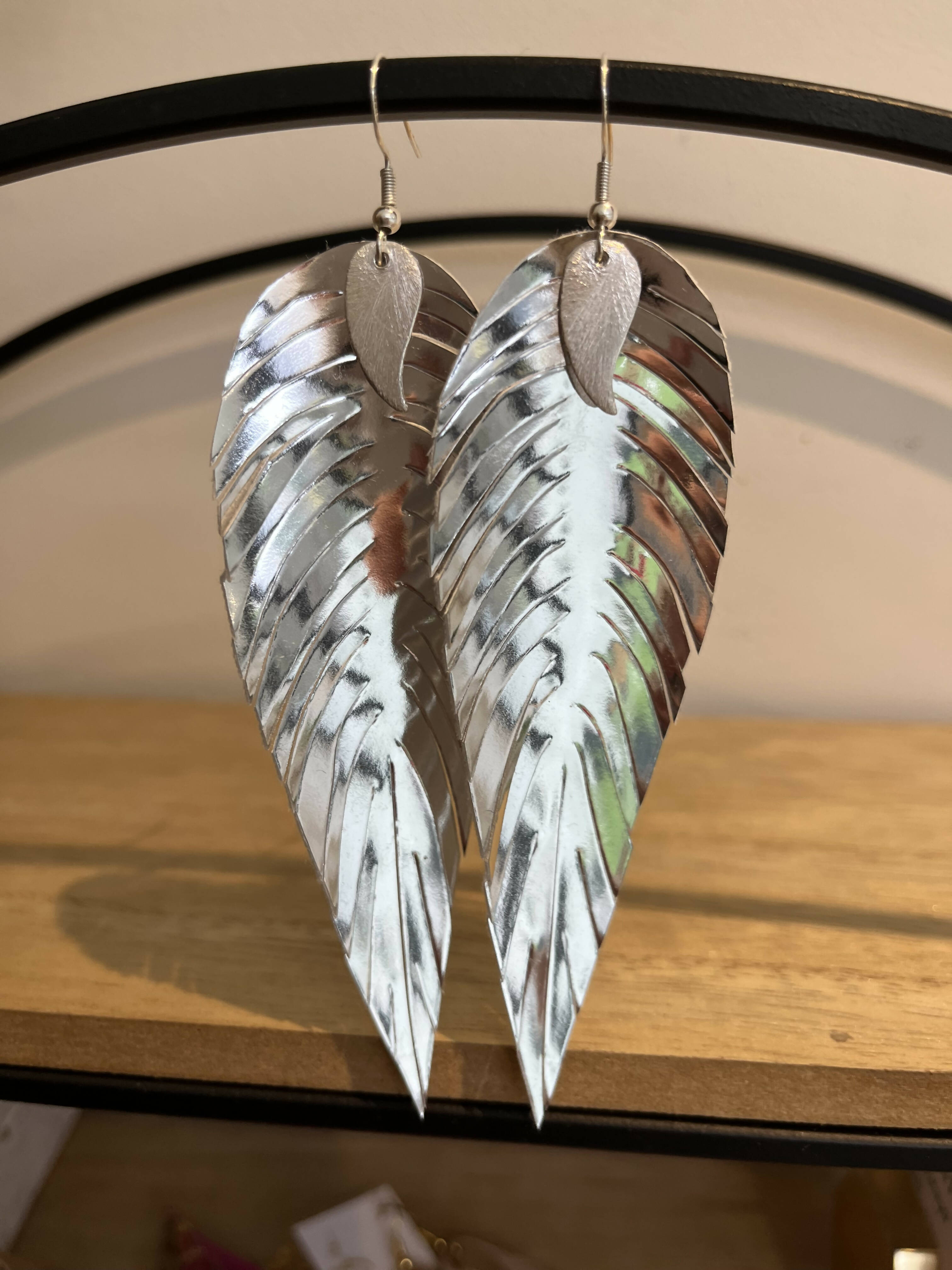 Silver mirrored feathered earrings.