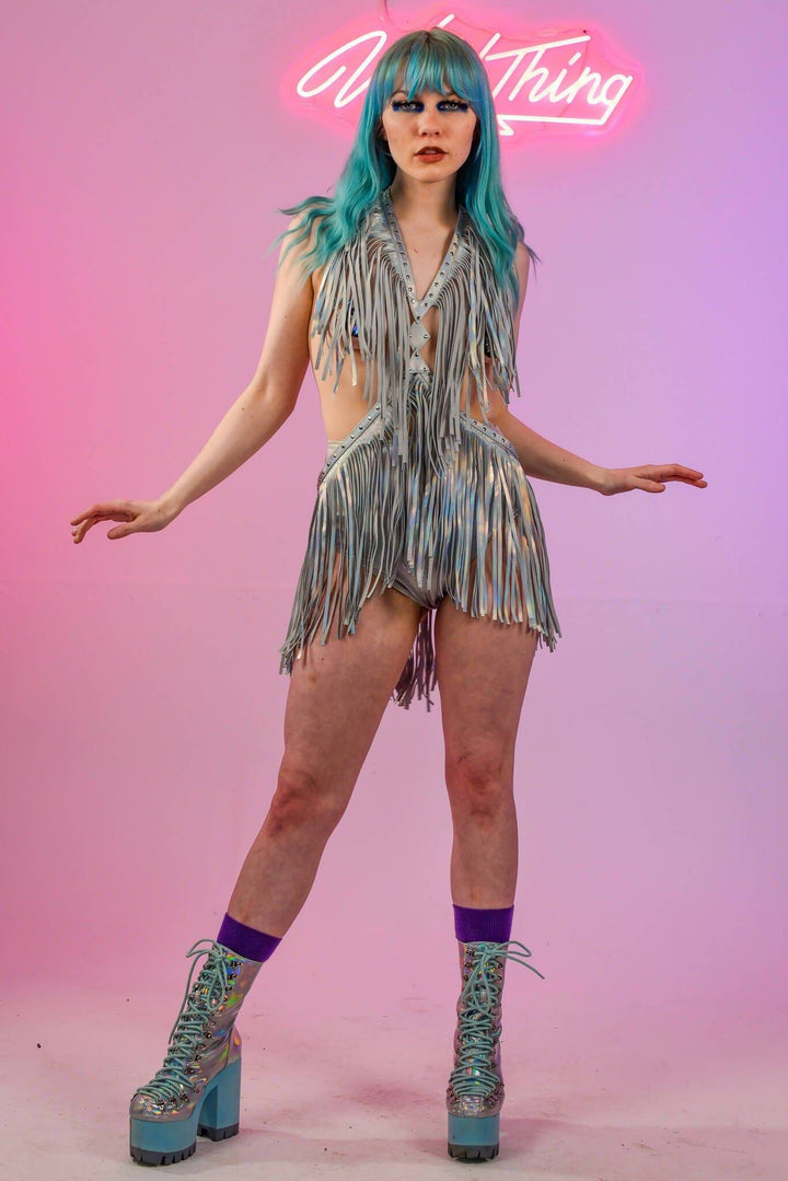 Model in holographic silver fringe harness dress, front view.