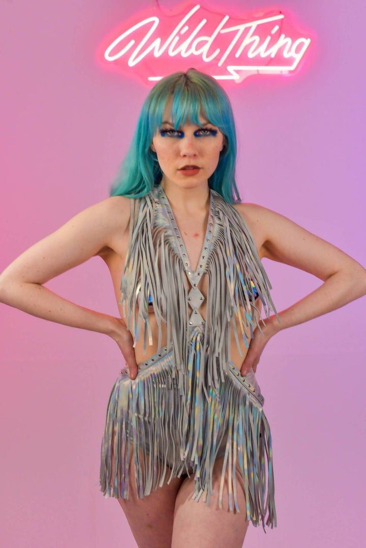 Close-up of model in holographic silver fringe harness dress.