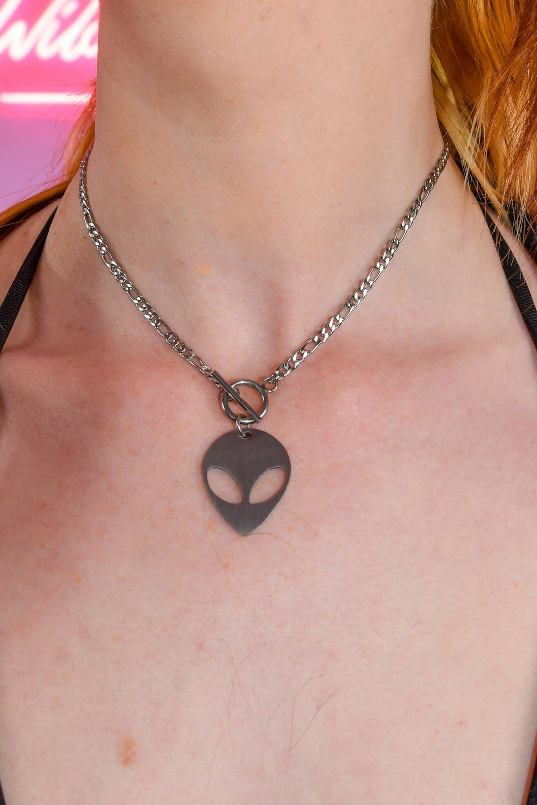 Close-up of alien charm chain necklace