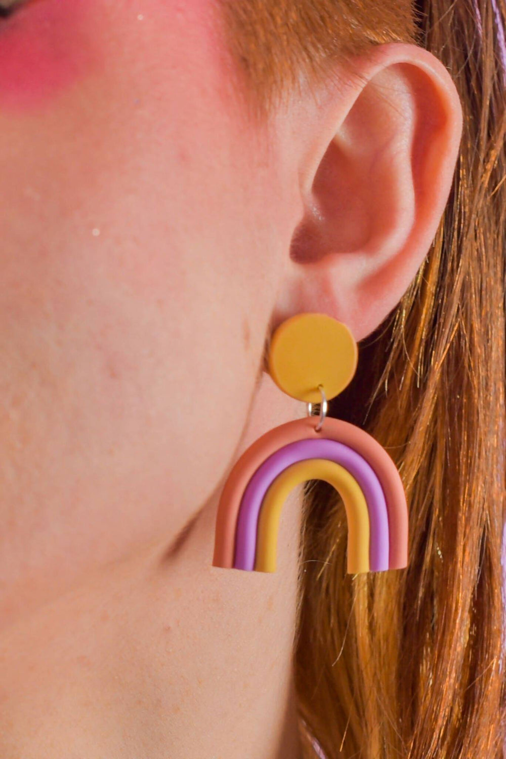 Close-up of pastel rainbow dangle earrings