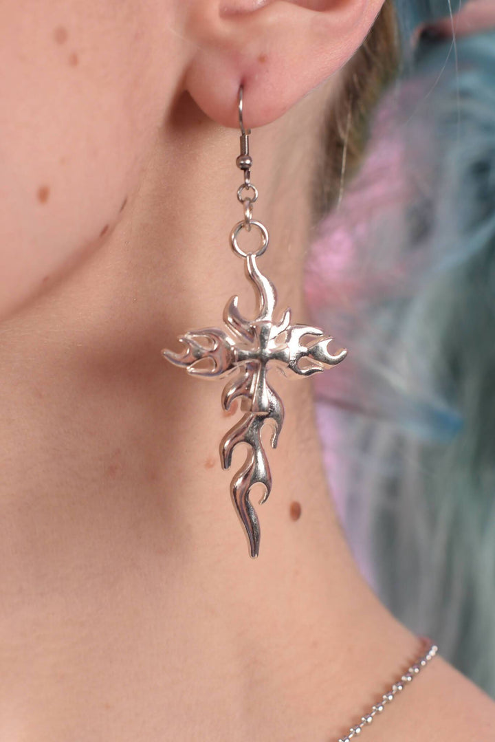 Silver tribal flame earring on ear