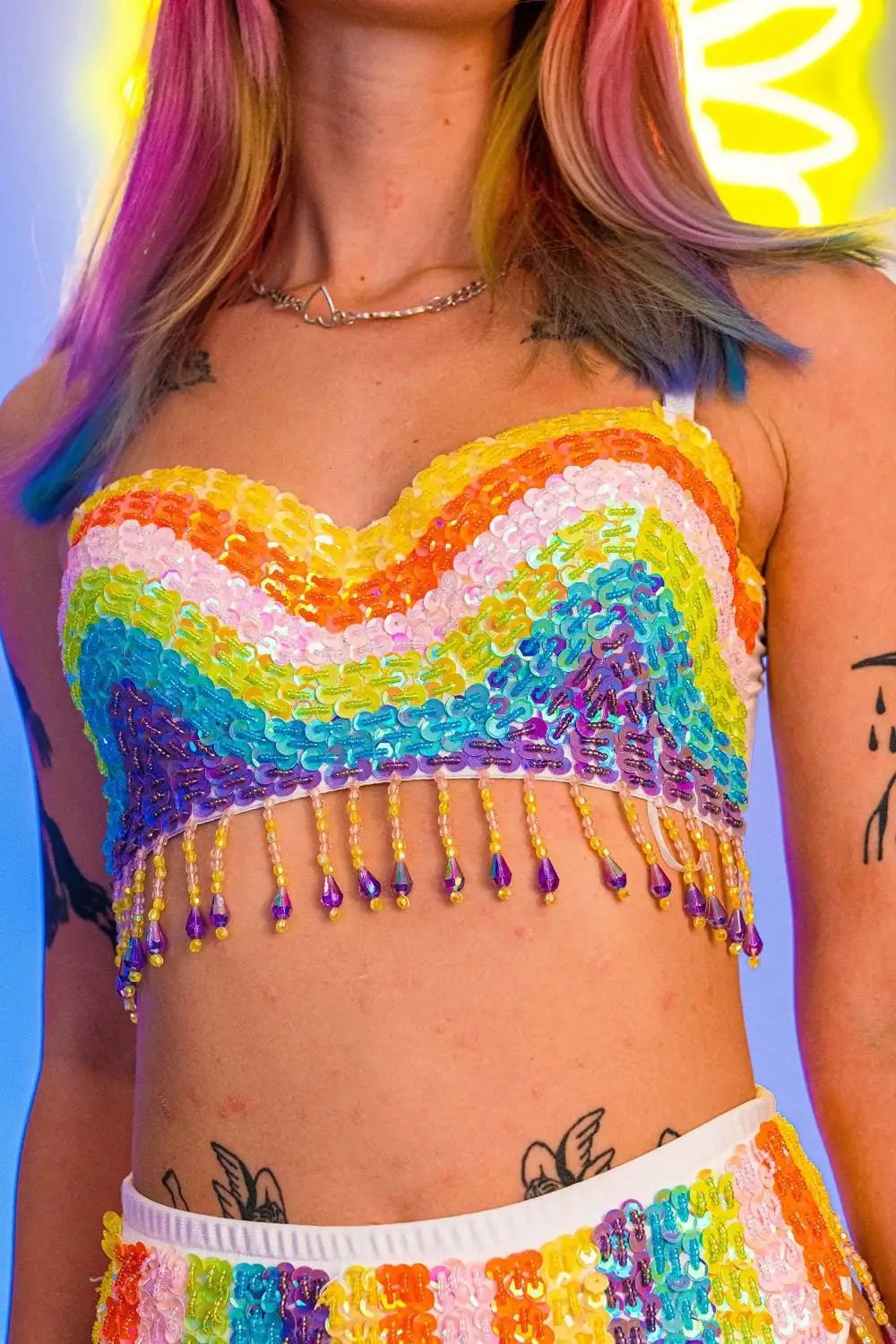 Close-up of rainbow sequin top with fringe.