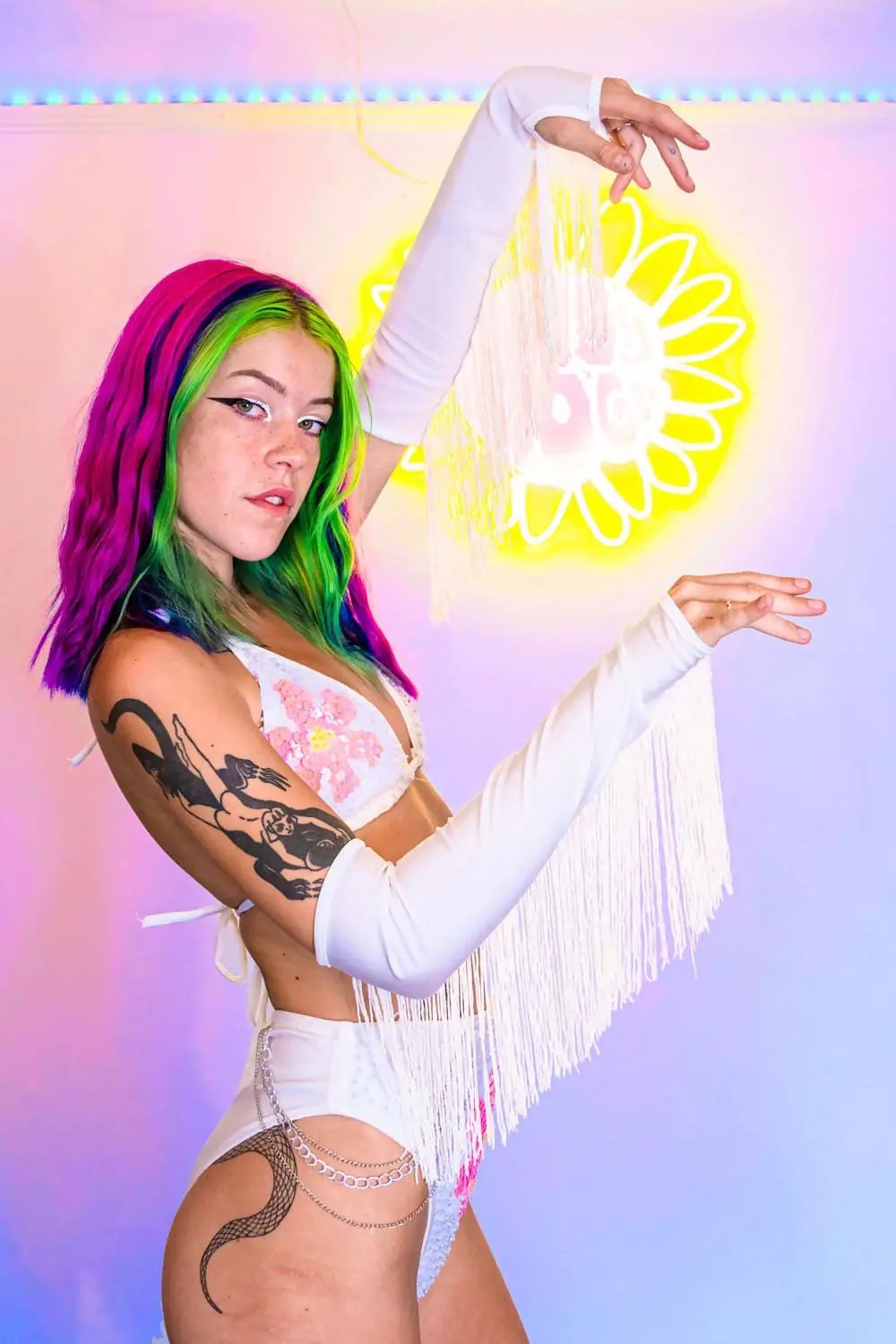 Model wearing Tilly White Fringed Arm Cuffs with colorful hair.